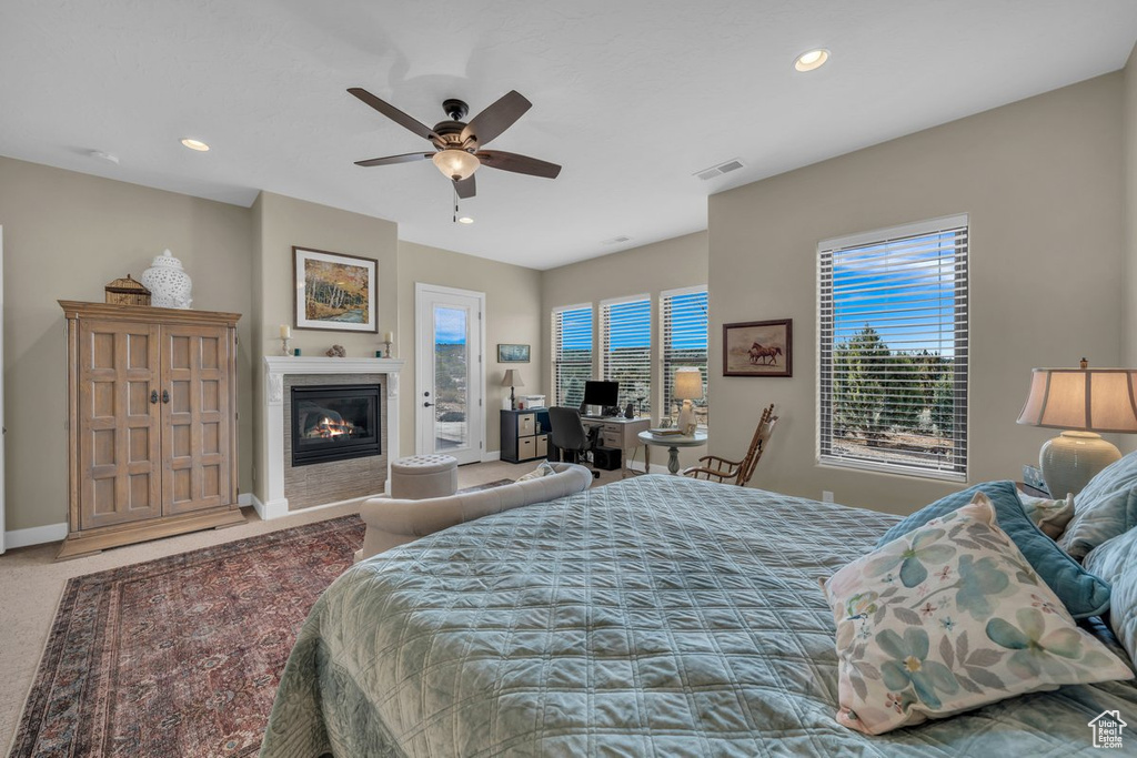 Bedroom with multiple windows, ceiling fan, and carpet flooring