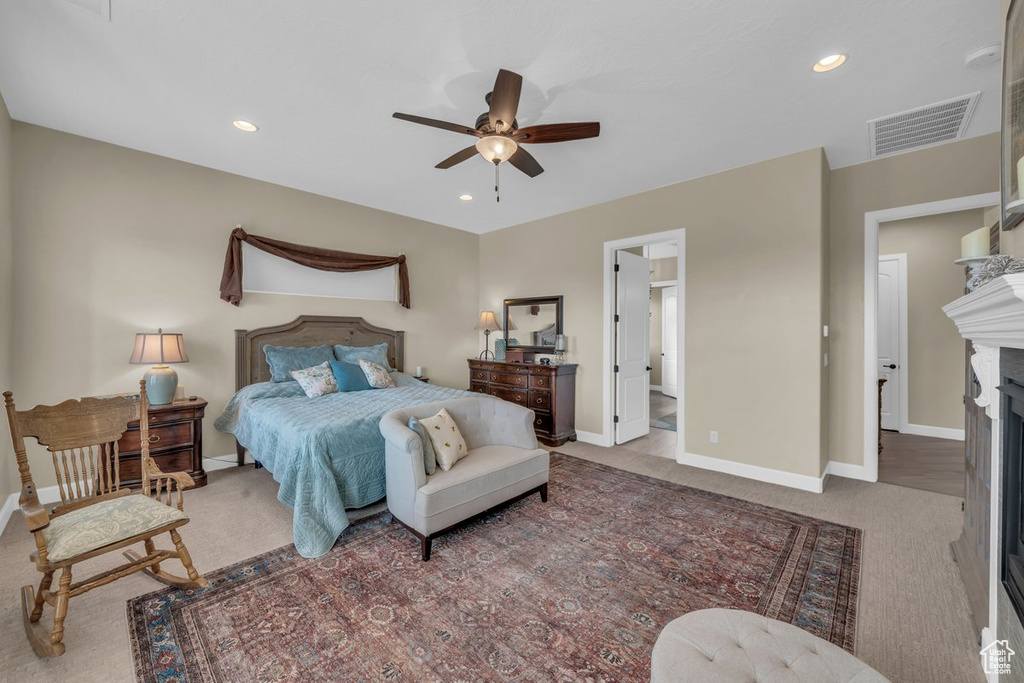 Bedroom featuring connected bathroom, ceiling fan, and carpet flooring