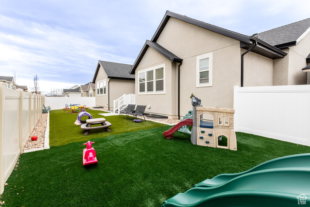 Exterior space featuring a lawn and a playground