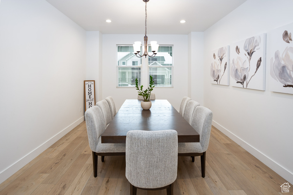 Dining room featuring light hardwood / wood-style flooring and a notable chandelier