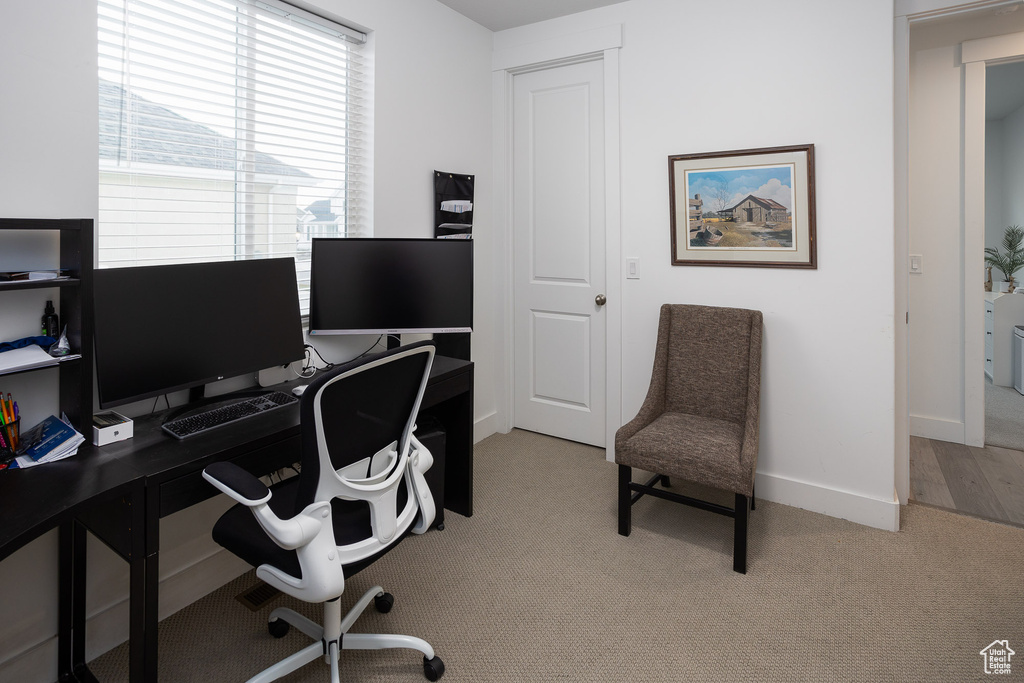 Home office with light colored carpet