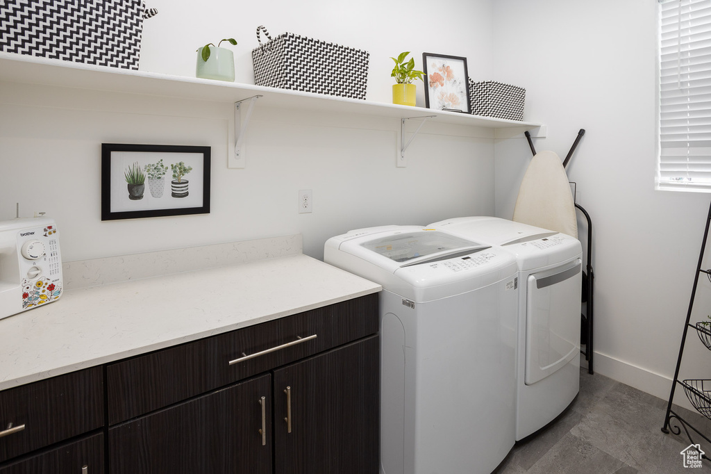 Clothes washing area with cabinets, independent washer and dryer, and tile floors
