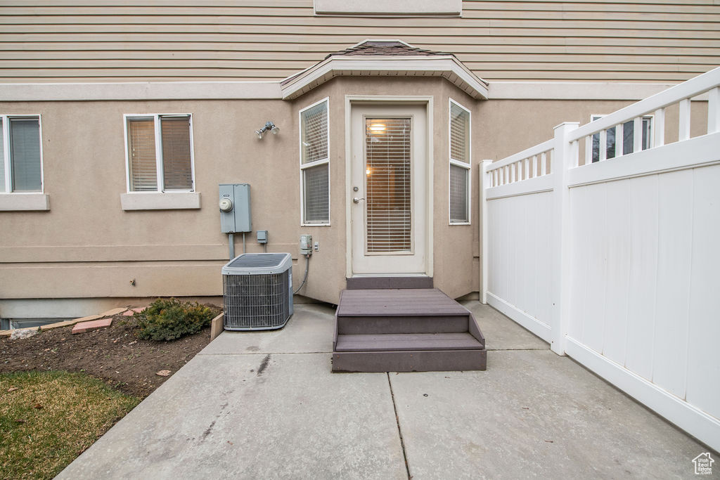 Doorway to property featuring a patio and central AC