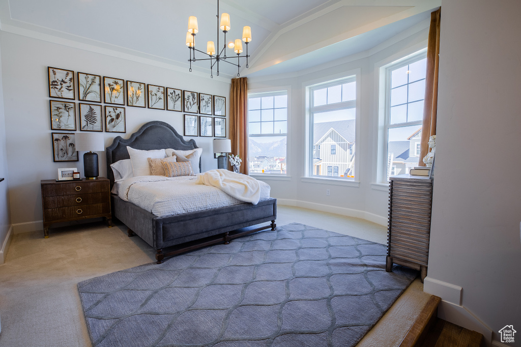 Bedroom featuring light carpet, vaulted ceiling, crown molding, and a notable chandelier