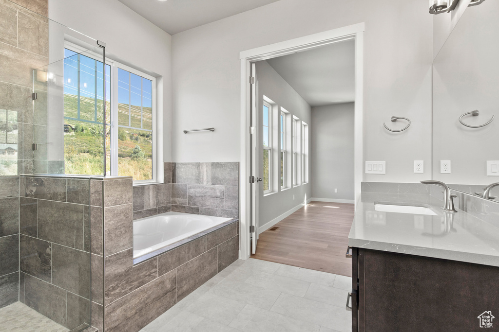 Bathroom with vanity, tile floors, and separate shower and tub