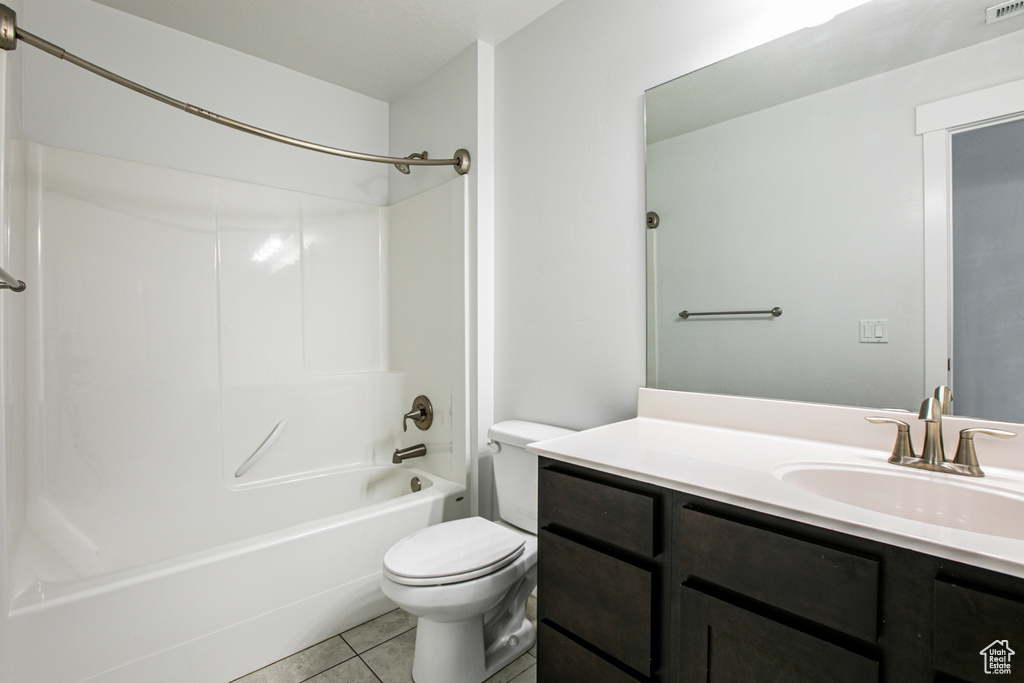 Full bathroom featuring shower / washtub combination, toilet, tile flooring, and vanity