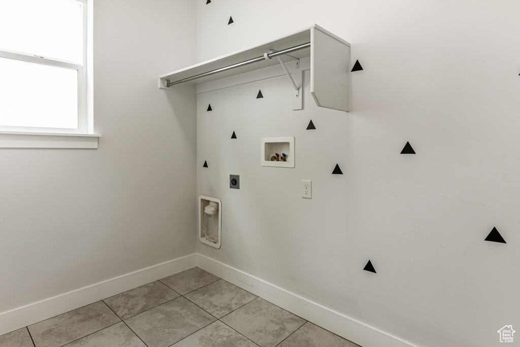 Washroom with washer hookup, electric dryer hookup, and light tile floors