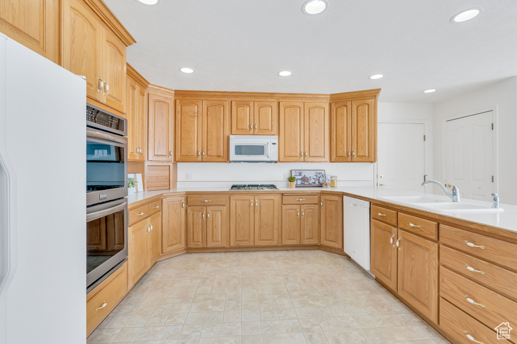 Kitchen featuring appliances with stainless steel finishes, light tile floors, and sink