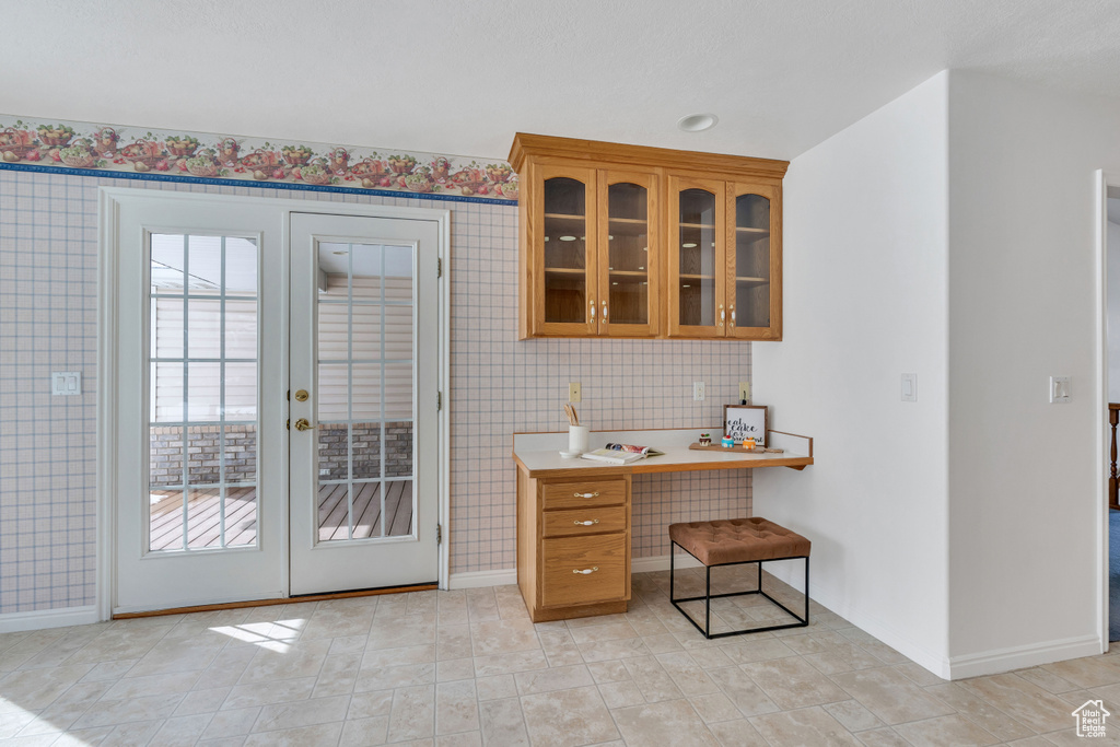 Kitchen featuring french doors and light tile floors