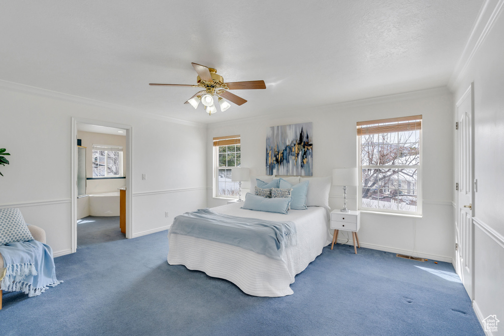 Bedroom with dark carpet, crown molding, and ceiling fan