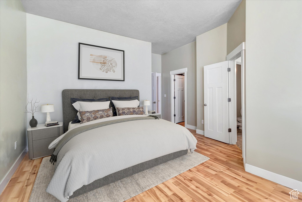 Bedroom featuring light hardwood / wood-style flooring and a textured ceiling