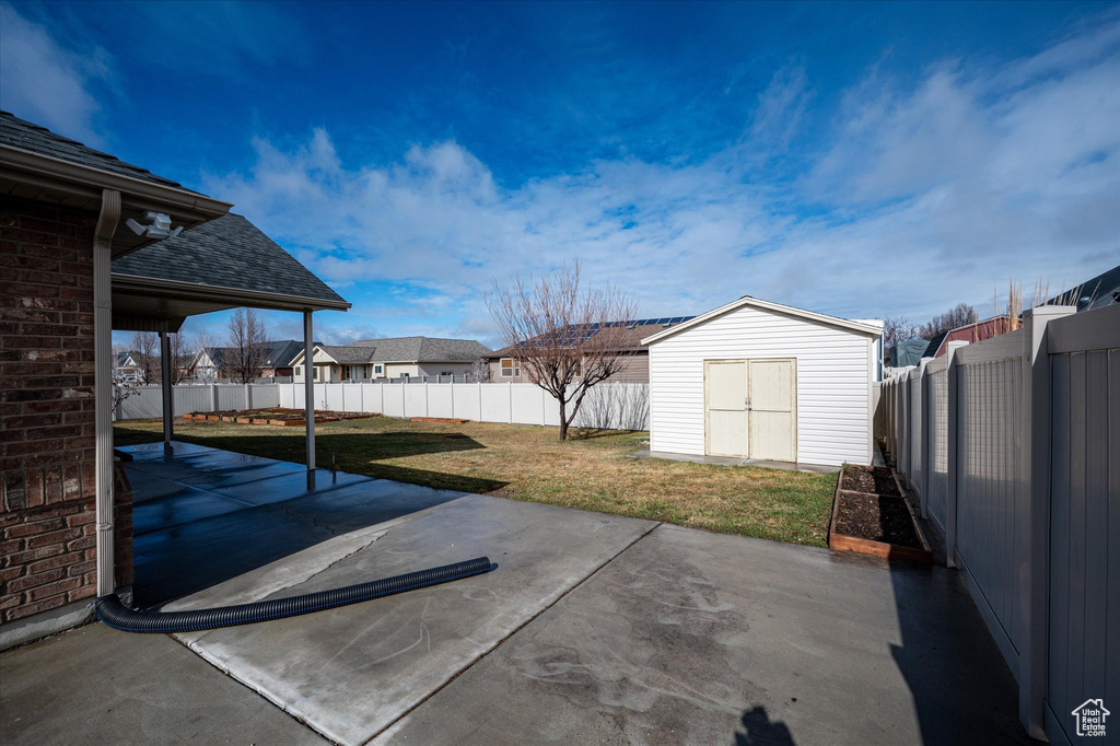 View of yard featuring a patio area and a storage unit