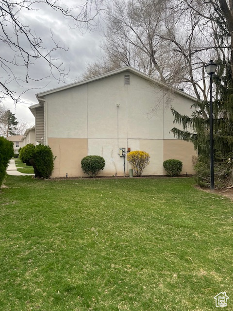 View of side of home with a lawn