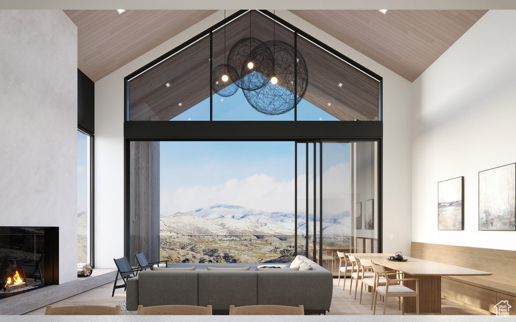 Living room featuring wood ceiling, a towering ceiling, and a mountain view