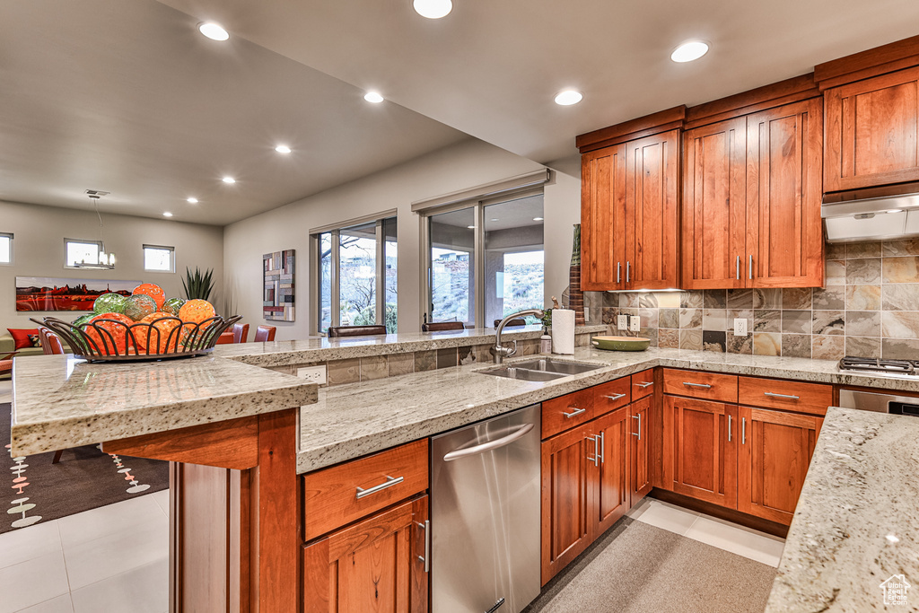 Kitchen featuring sink, light tile floors, stainless steel appliances, and tasteful backsplash