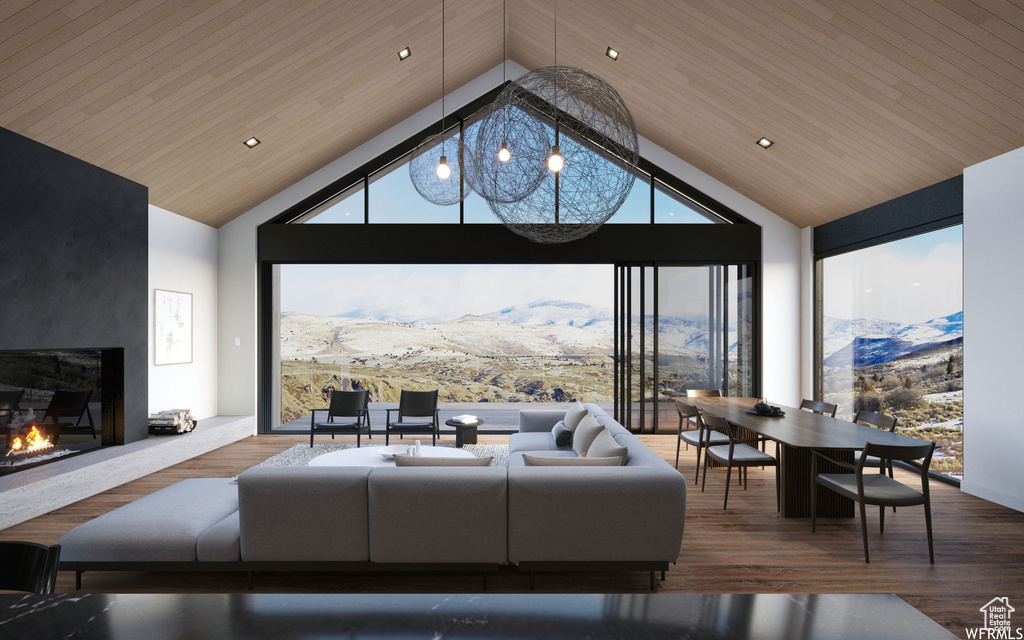 Living room featuring dark hardwood / wood-style floors, a mountain view, and high vaulted ceiling