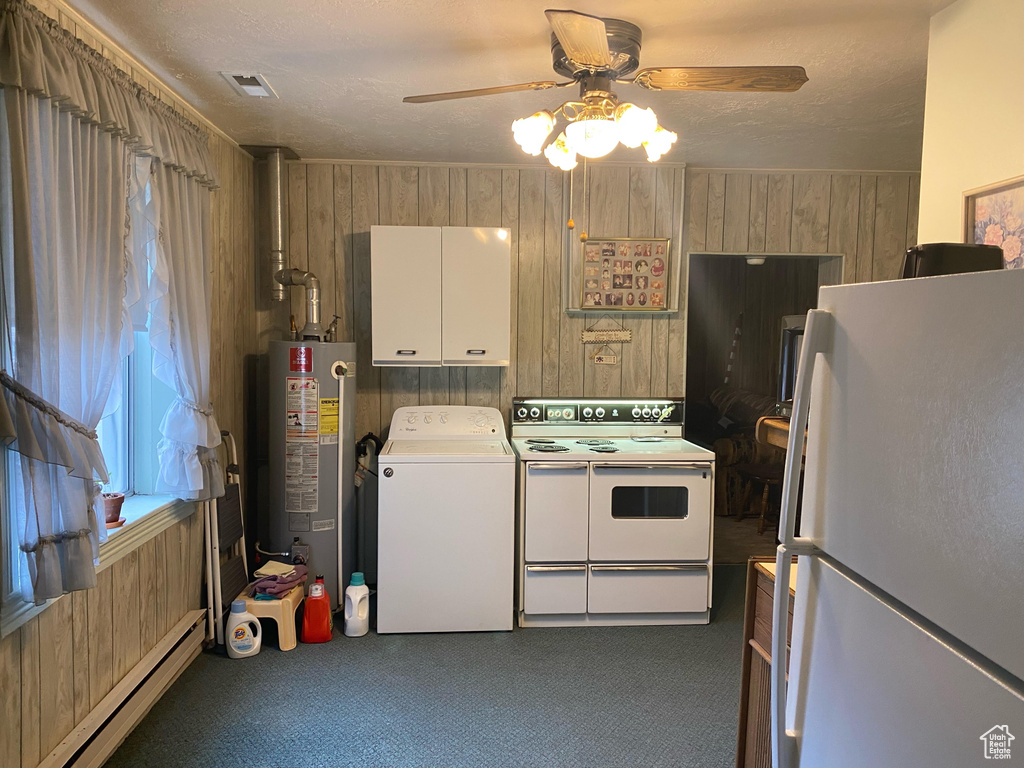 Laundry room featuring dark colored carpet, washer / dryer, ceiling fan, and water heater