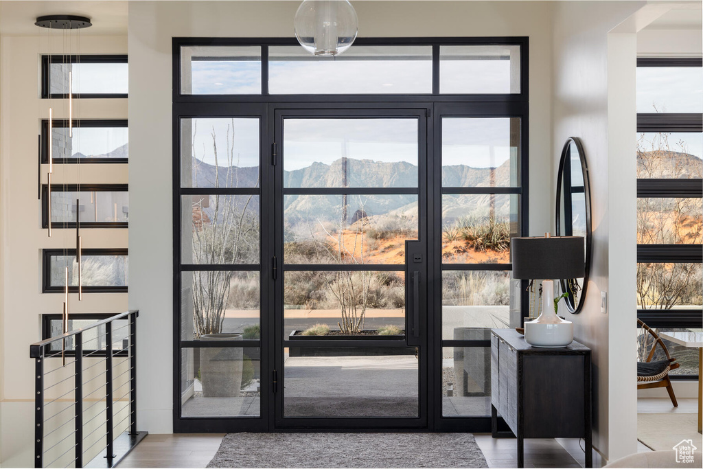Doorway to outside with light hardwood / wood-style flooring and a mountain view