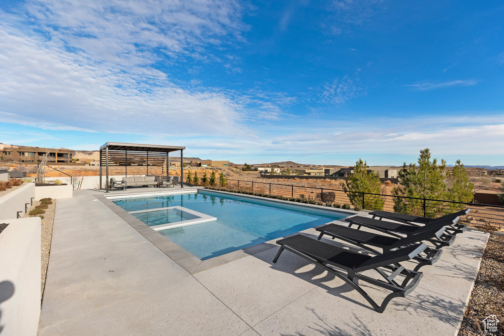 View of pool featuring an in ground hot tub, a patio area, and a pergola