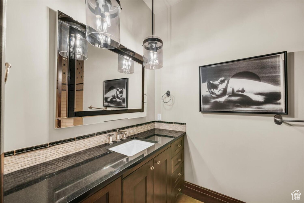 Bathroom featuring vanity and backsplash