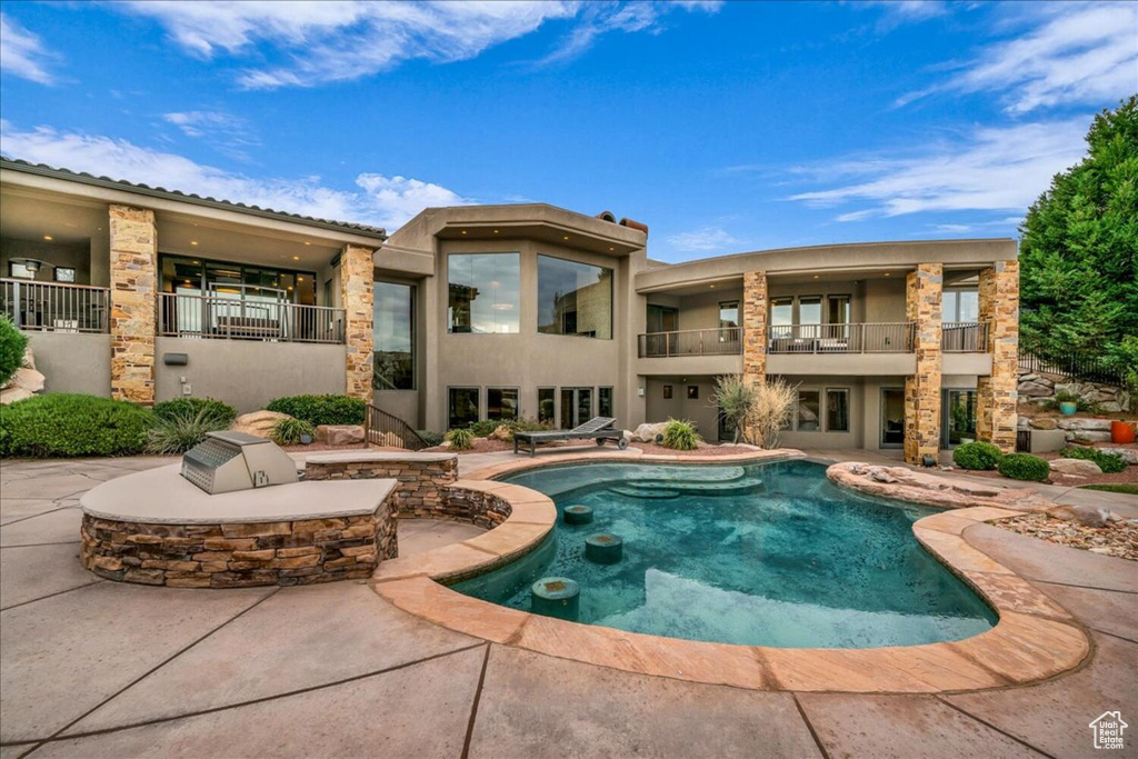 View of pool featuring a patio and a fire pit