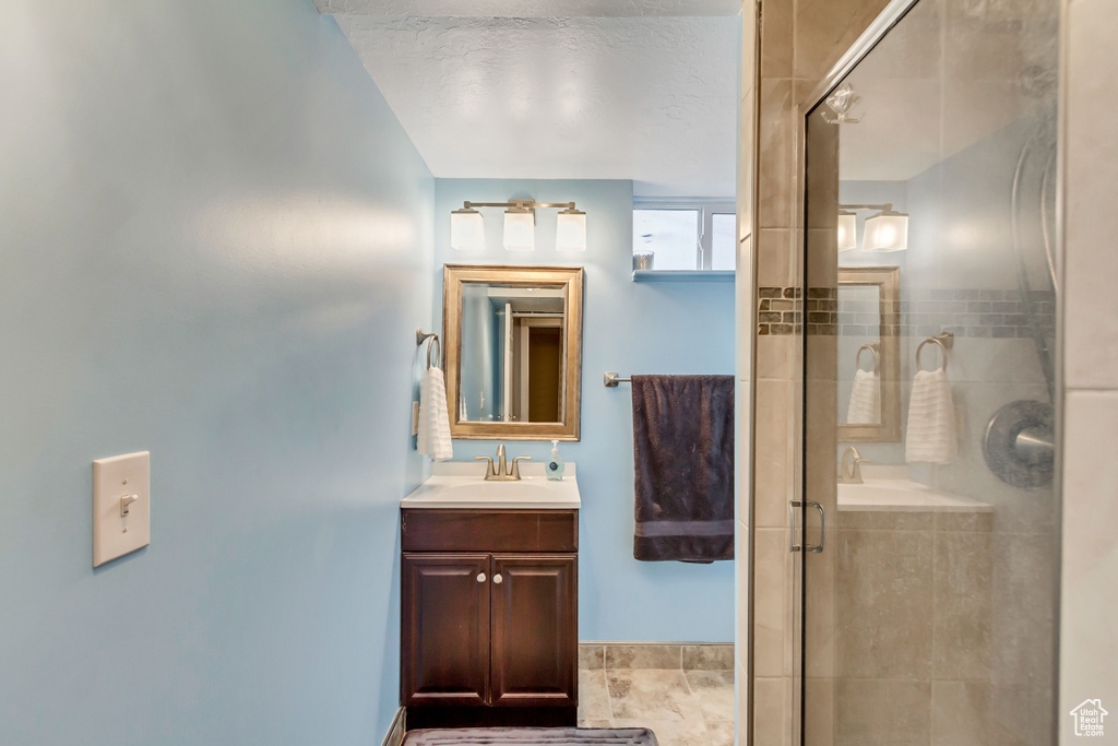 Bathroom with vanity, tile flooring, and separate shower and tub