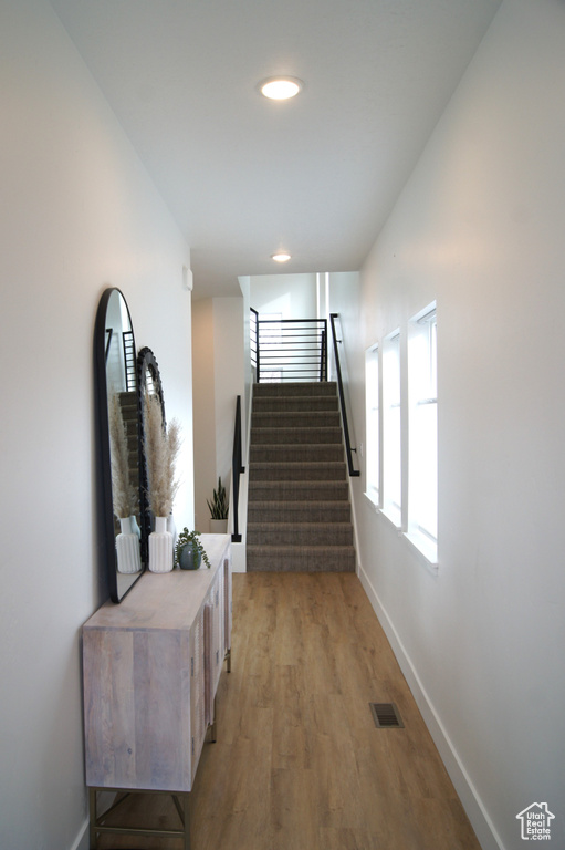 Stairs with light hardwood / wood-style floors