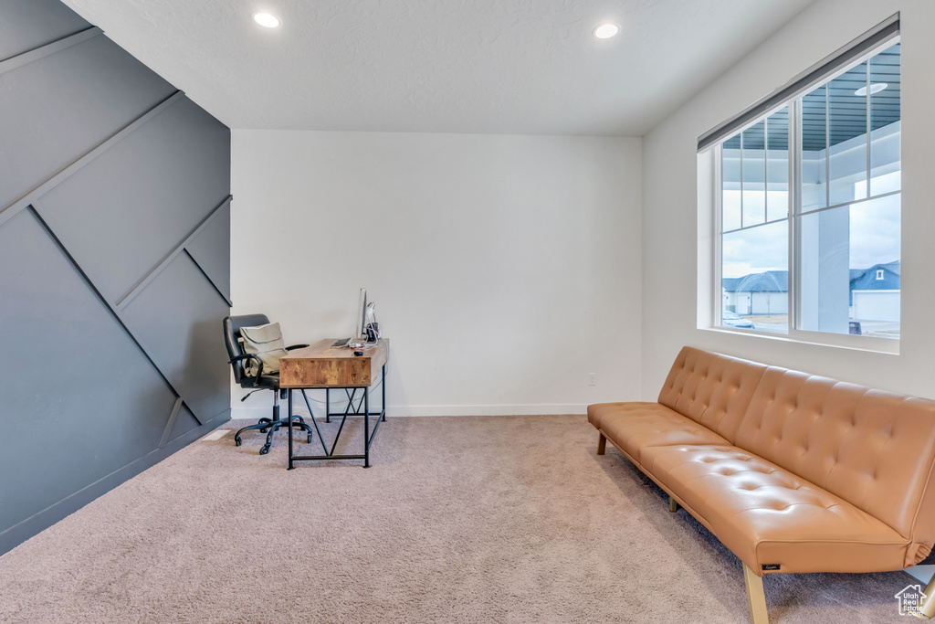 Living area featuring light carpet