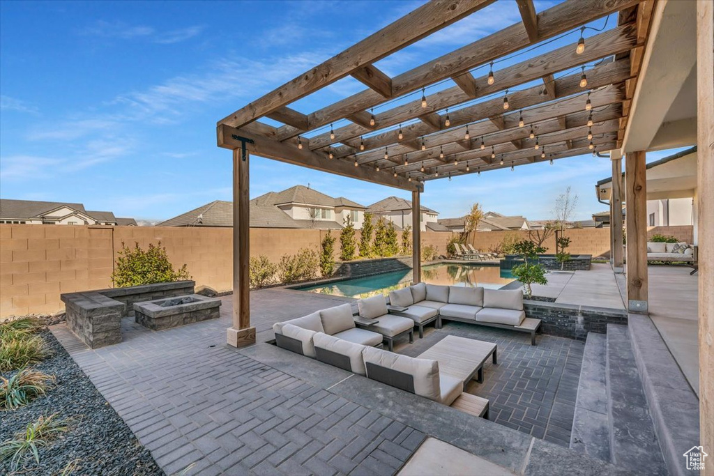 View of terrace with a fenced in pool, a pergola, and an outdoor living space