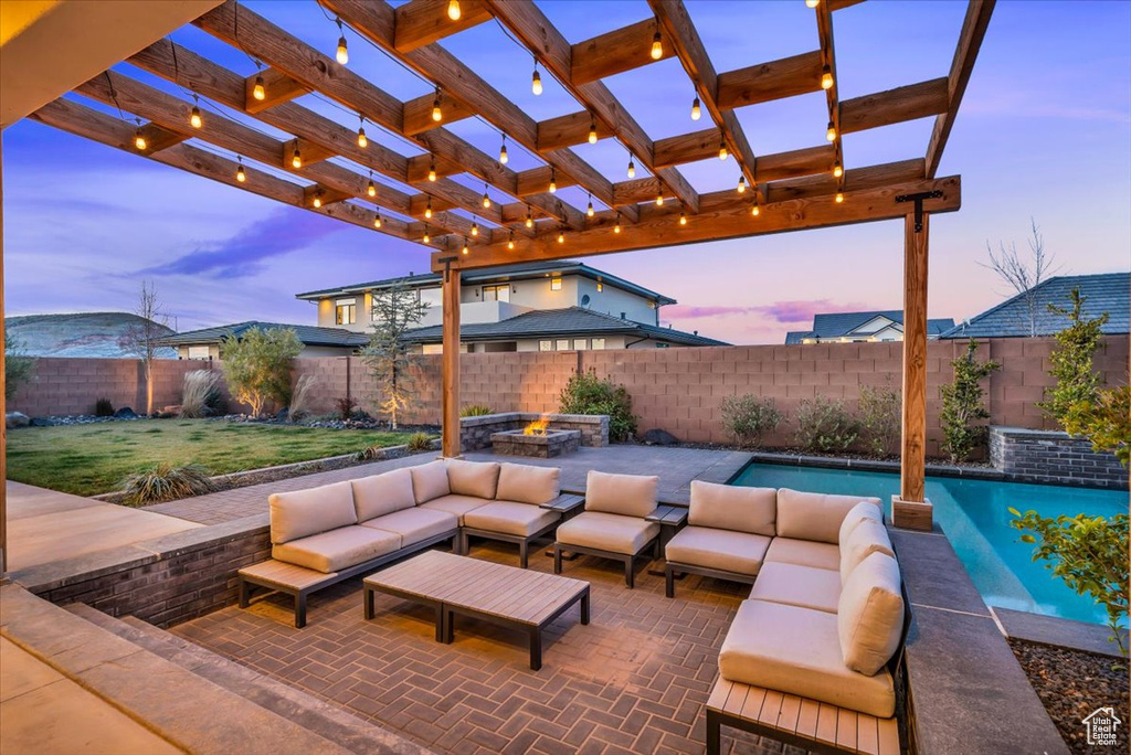 Patio terrace at dusk featuring a pergola and outdoor lounge area