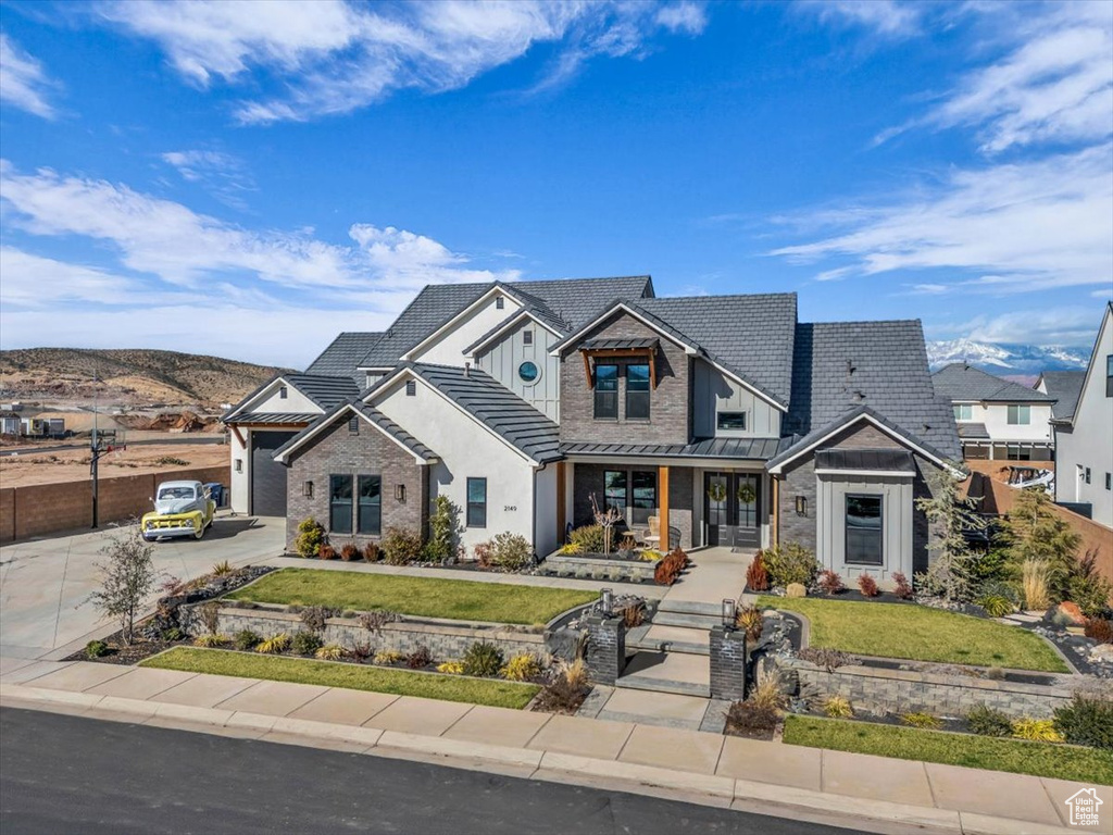 Craftsman-style home with a front yard and a garage