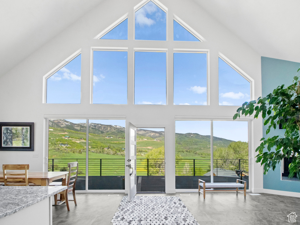 Sunroom featuring a mountain view and lofted ceiling
