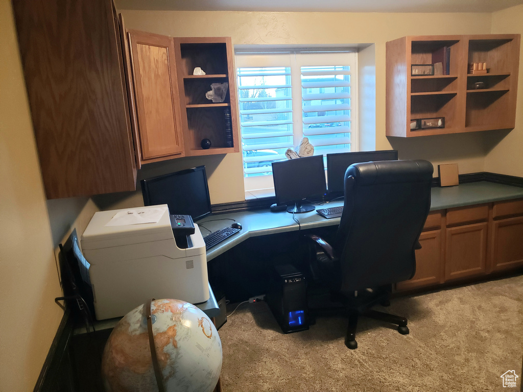 Carpeted office with built in desk