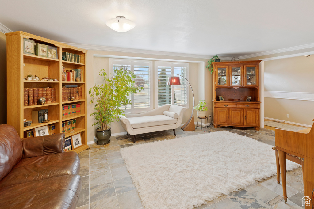 Living area featuring light tile flooring and crown molding