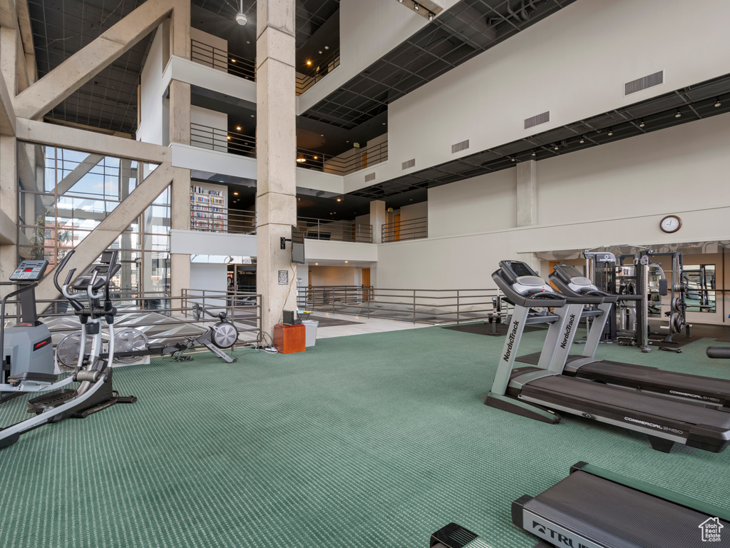 Gym with a high ceiling and carpet flooring