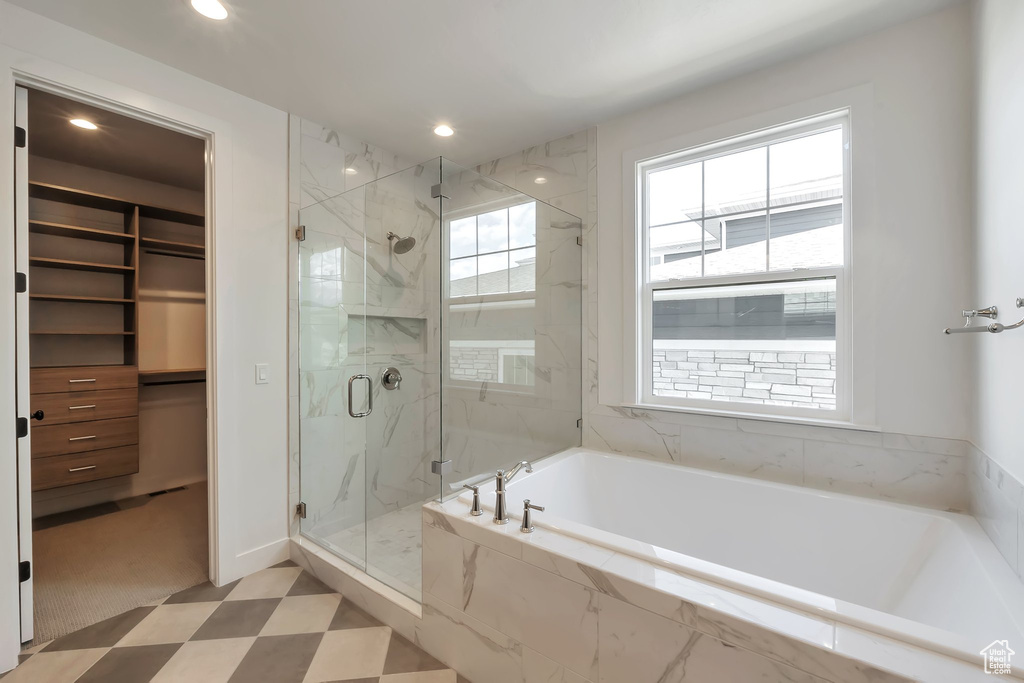 Bathroom featuring independent shower and bath and tile flooring