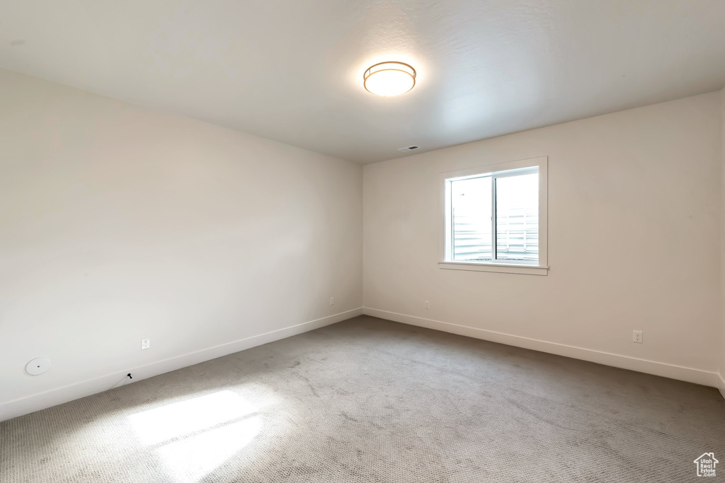 Unfurnished room with light colored carpet