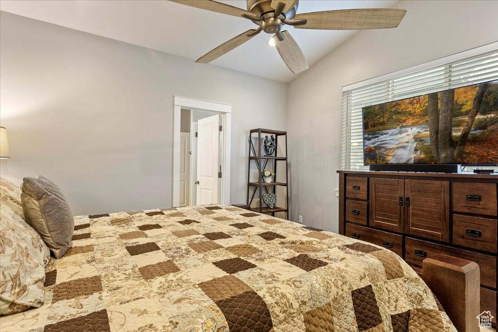 Bedroom with ceiling fan and vaulted ceiling