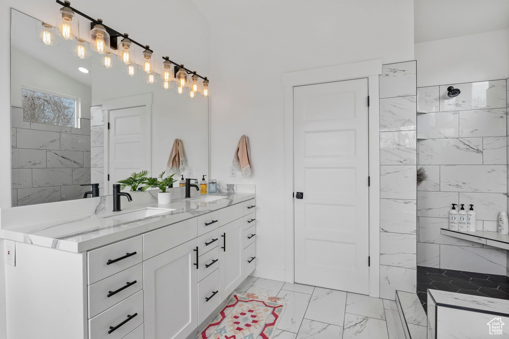 Bathroom featuring lofted ceiling, tile floors, and dual bowl vanity