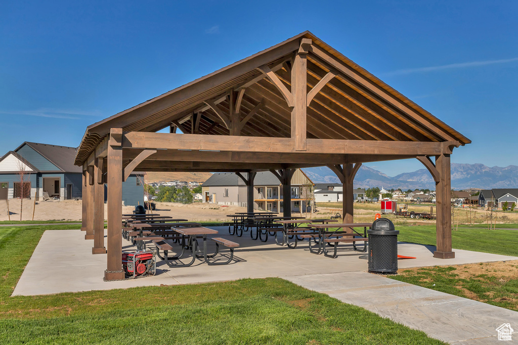 Surrounding community featuring a mountain view, a patio area, a gazebo, and a yard
