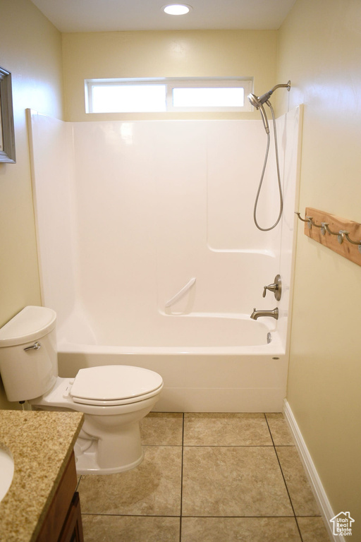 Full bathroom featuring bathtub / shower combination, vanity, tile flooring, and toilet