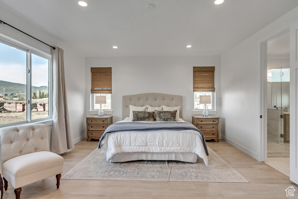 Bedroom featuring light hardwood / wood-style floors and ensuite bathroom