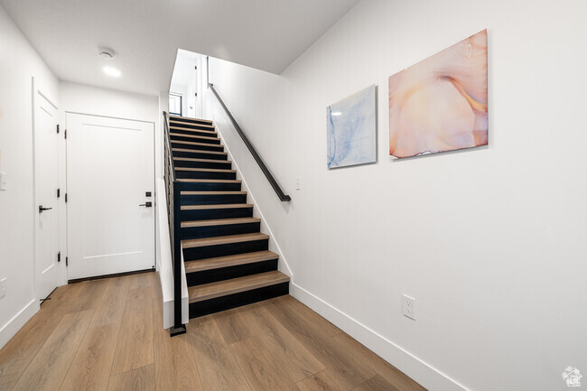 Staircase featuring light wood-type flooring