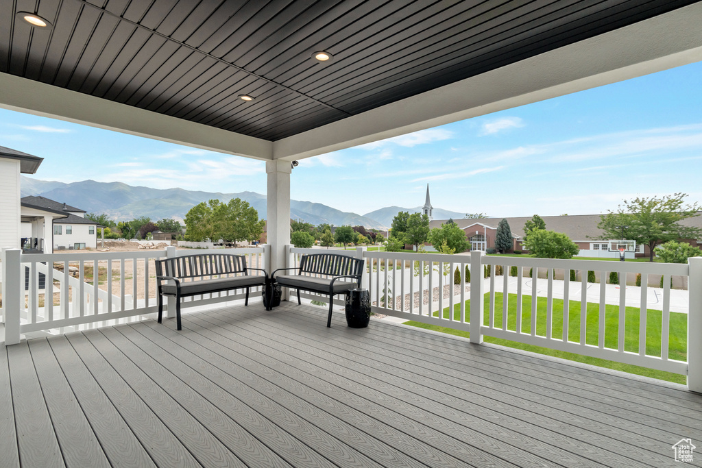 Wooden terrace featuring a yard and a mountain view