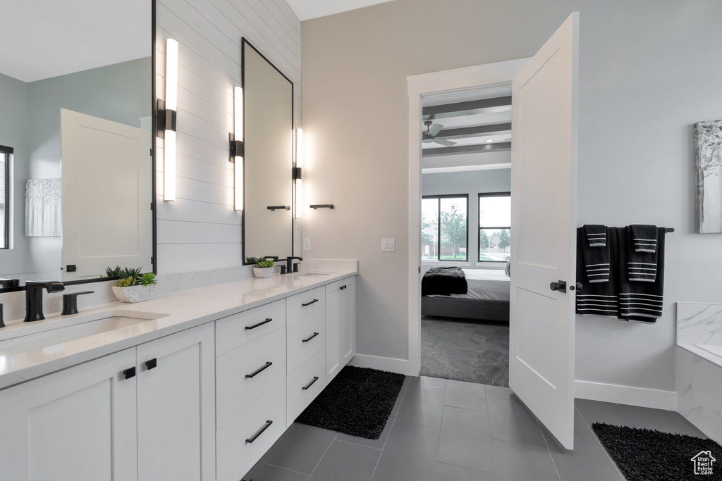 Bathroom featuring double vanity, tile floors, and ceiling fan