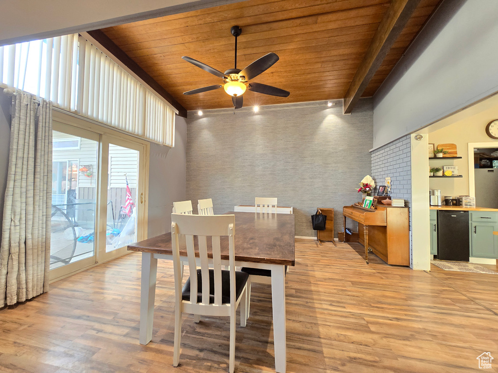 Dining room featuring plenty of natural light, light hardwood / wood-style floors, ceiling fan, wooden ceiling, and beamed ceiling