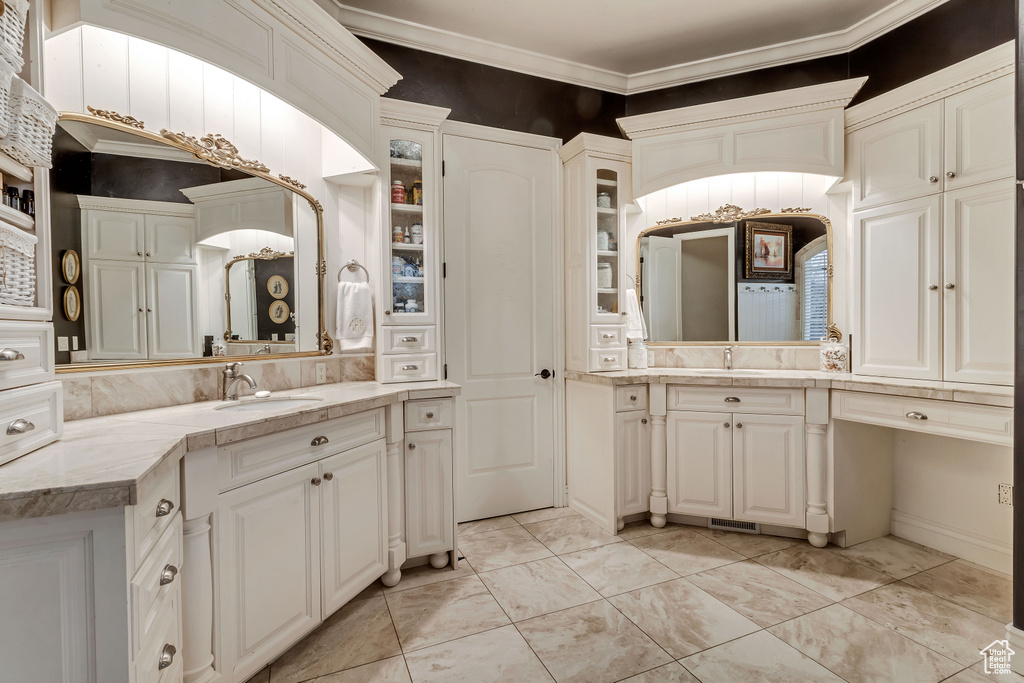 Bathroom with vanity, ornamental molding, and tile floors