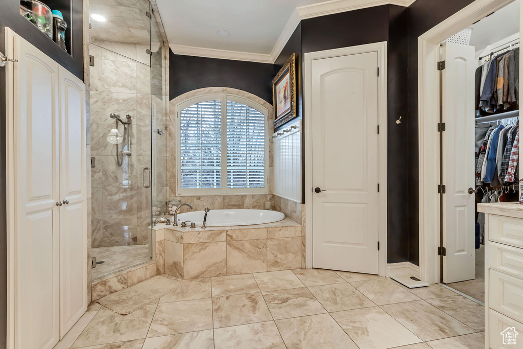 Bathroom featuring vanity, separate shower and tub, tile floors, and crown molding