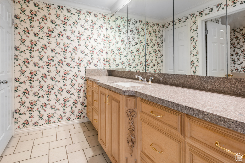 Bathroom featuring vanity, tile flooring, and ornamental molding