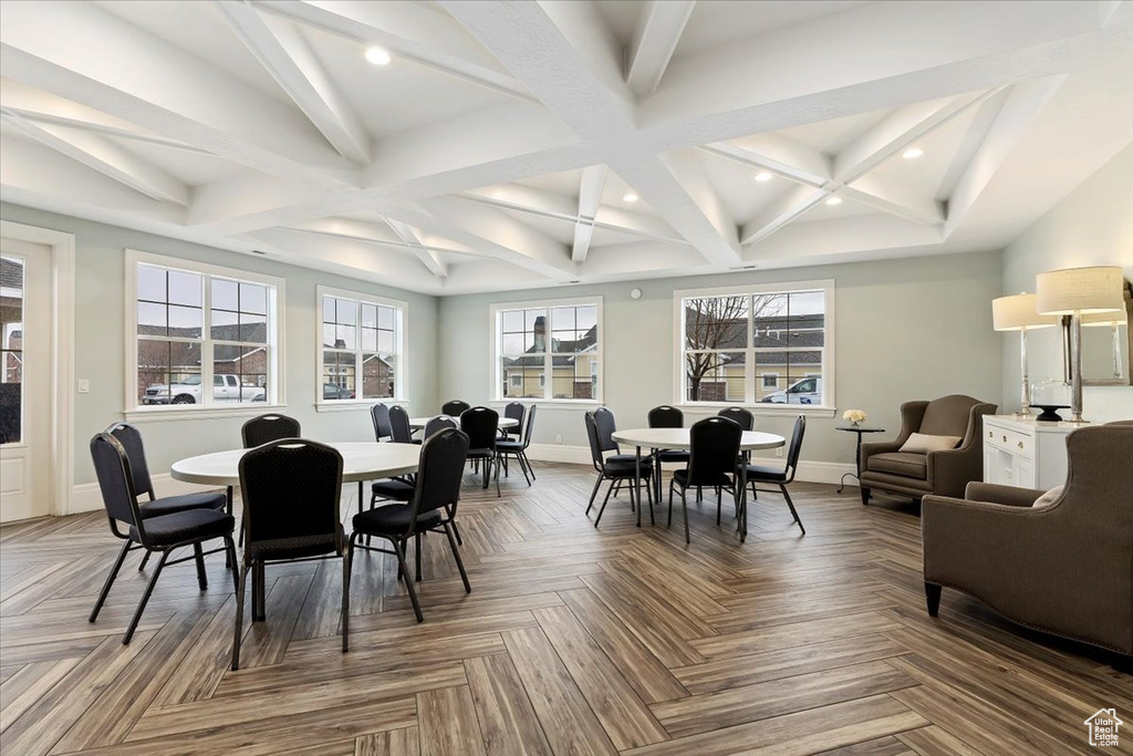 Dining room featuring coffered ceiling, beamed ceiling, and dark parquet floors